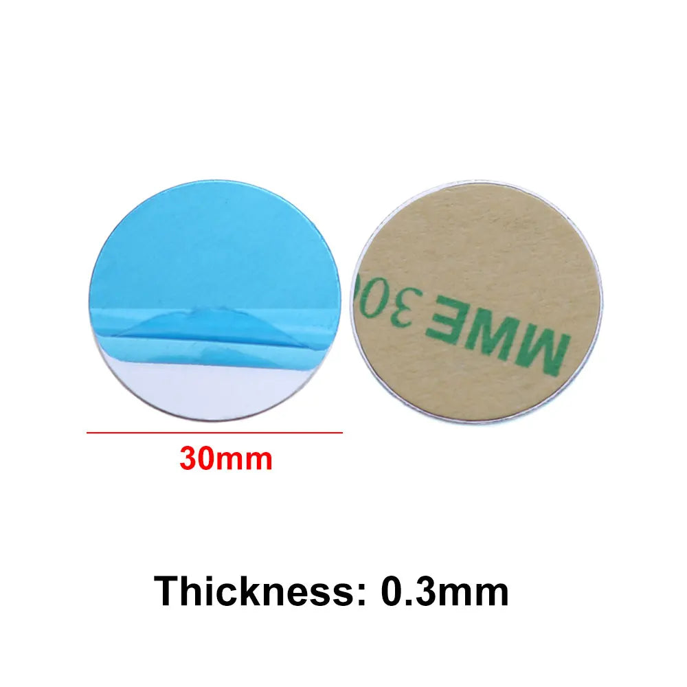 Two 30mm round, 0.3mm thick adhesive metal discs shown from the front and back with blue and beige peel-off liners.