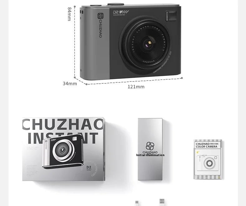 Grey plastic instant camera with a lens, flash, and dimension labels, displayed with its packaging and accessories.