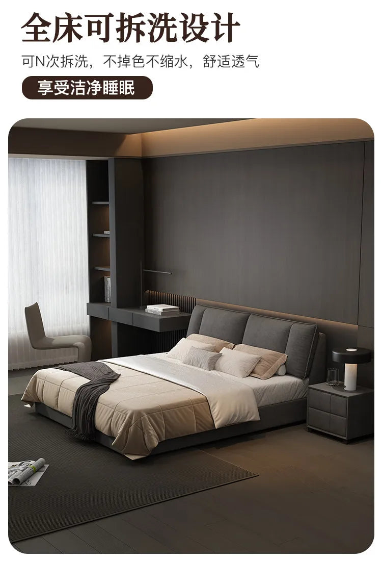 Modern charcoal grey upholstered double bed with a cushioned headboard, set in a minimalist bedroom.