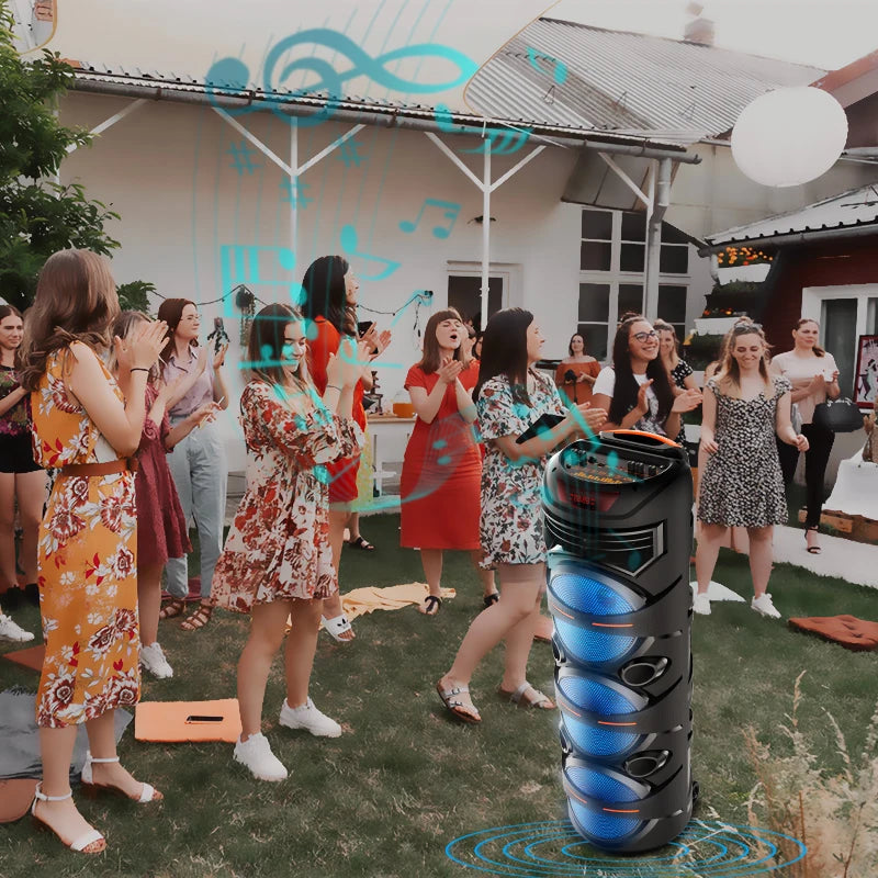 Black 8-inch wireless party speaker with glowing blue LED speakers, shown in a garden setting.