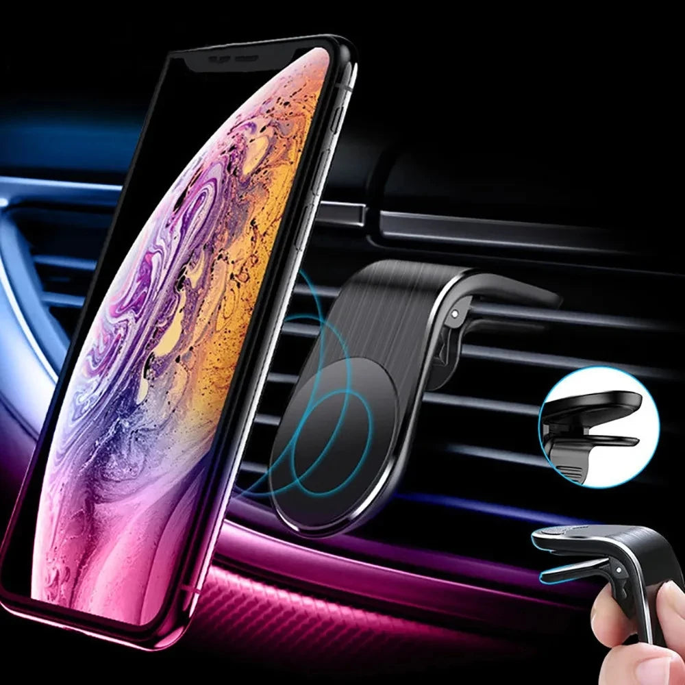Black magnetic car phone mount clipped to an air vent, holding a smartphone with a colorful, abstract wallpaper.