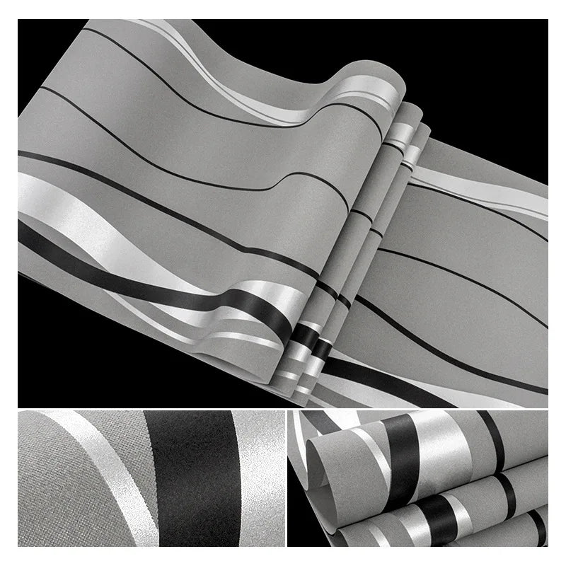 Modern wallpaper featuring grey, black, and silver flowing abstract stripes on a textured matte background.