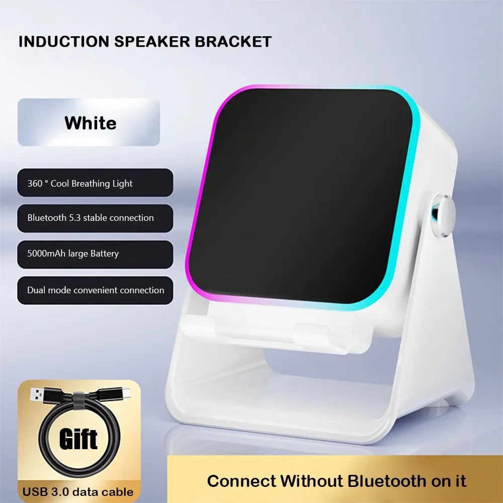 White rechargeable induction speaker and phone stand with colourful LED edge lighting and included USB charging cable.