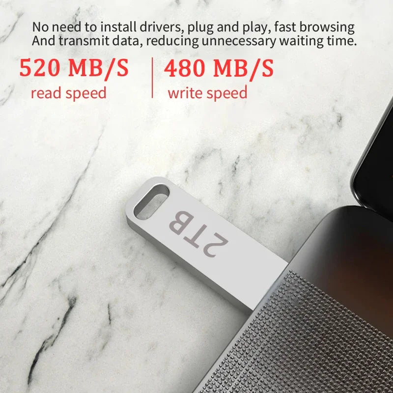 Sleek silver 2TB portable USB flash drive plugged into a laptop, highlighting high-speed data transfer performance.