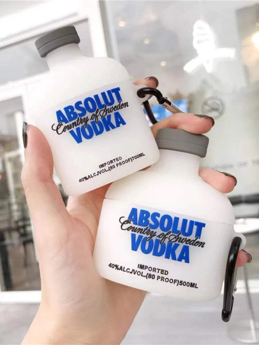 White silicone AirPods case shaped like an Absolut Vodka bottle with blue branding and a black carabiner clip.