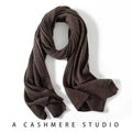 Brown knitted cashmere scarf draped in a loose loop with ribbed ends.