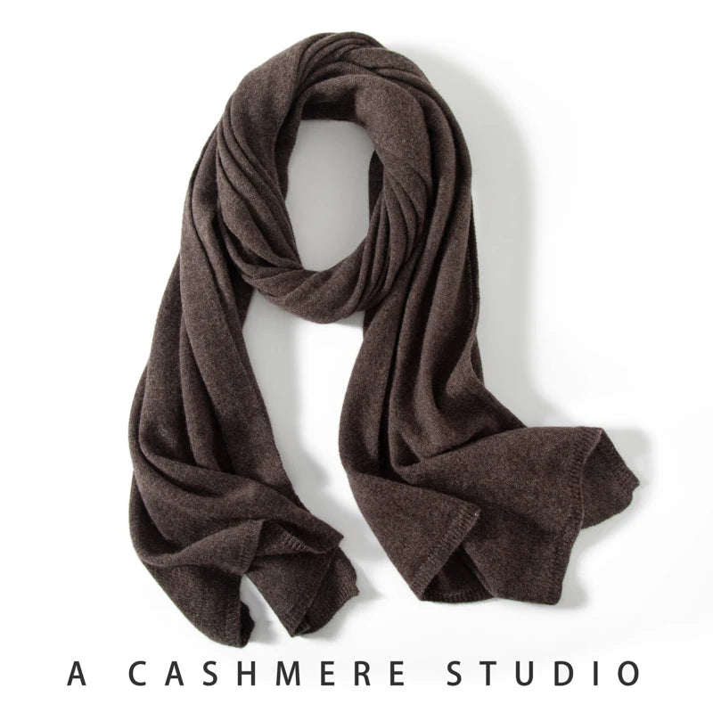 Brown knitted cashmere scarf draped in a loose loop with ribbed ends.
