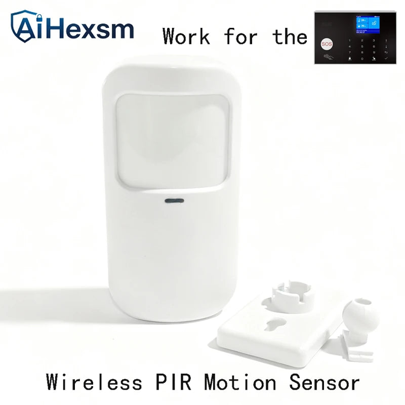 White wireless PIR motion sensor with mounting bracket and a small digital alarm control panel in the corner.
