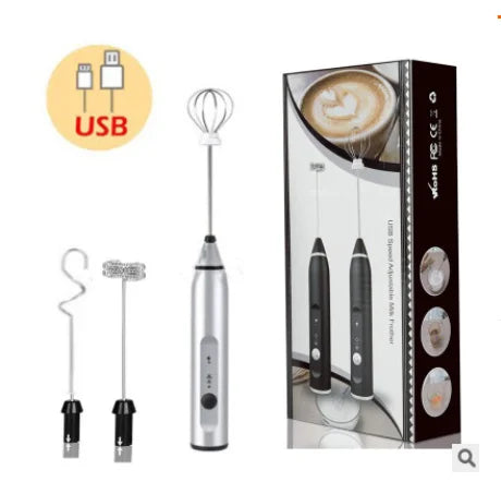 Silver USB-rechargeable handheld milk frother with three interchangeable whisk attachments and its retail packaging.