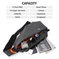Grey anti-theft crossbody sling bag with orange interior, shown holding a tablet, camera, phone, and daily essentials.