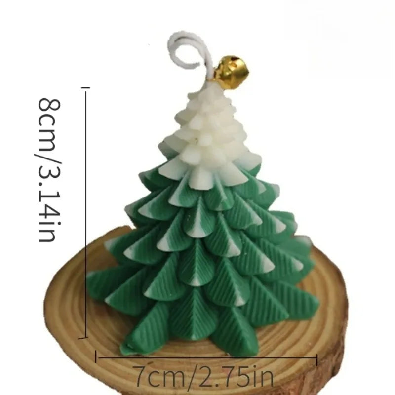 Green and white Christmas tree-shaped candle on a wood slice base, topped with a small gold bell. Height: 8cm.