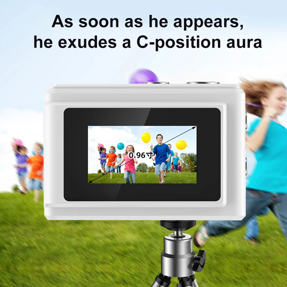 White digital camera with a 0.96-inch screen mounted on a small metal tripod, showing a photo of children playing.