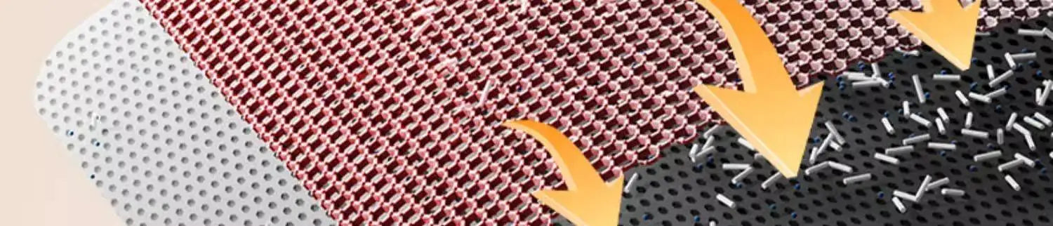 Close-up of a dual-layer waterproof cat litter mat with a pink honeycomb mesh top and a black trap-layer base.