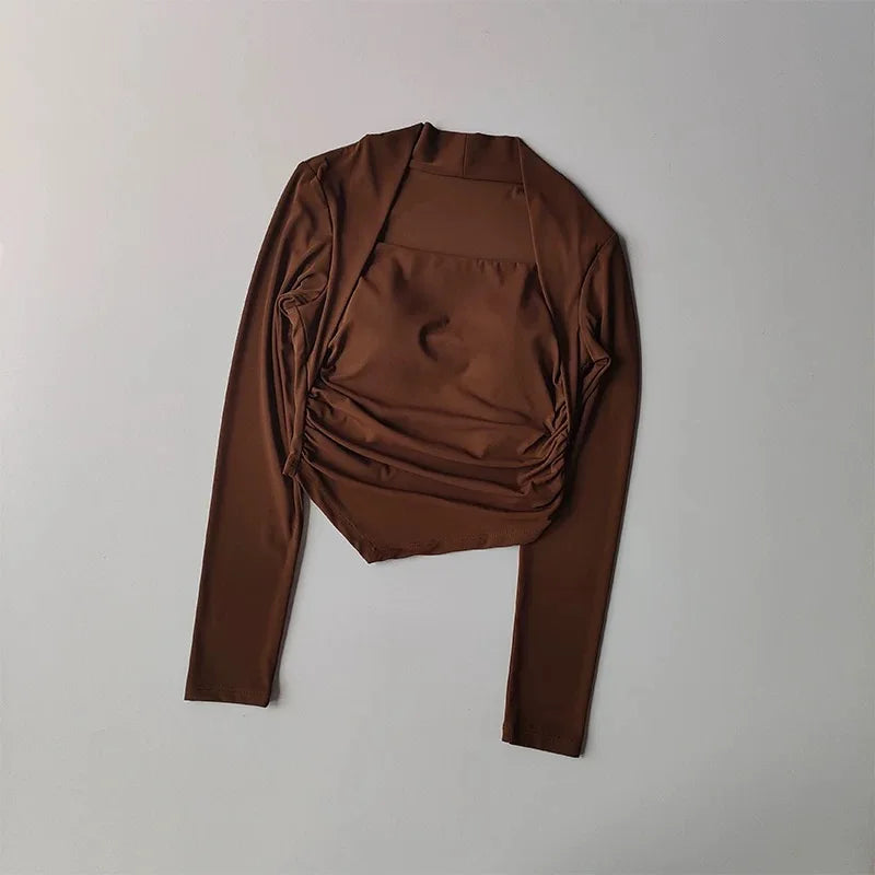 Brown long-sleeve crop top with a square neckline, ruched front detail, and layered-look shrug design.