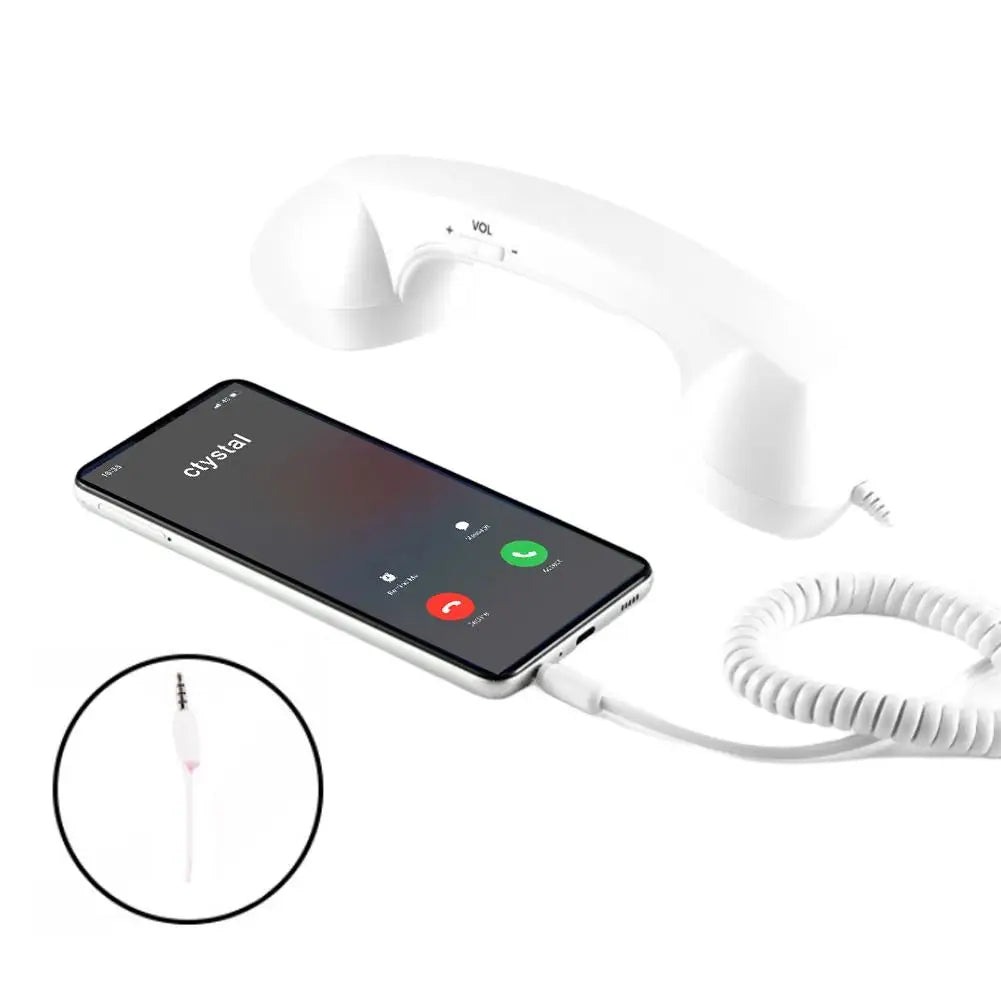 White vintage-style corded phone handset with volume control, connected to a smartphone via a coiled cable.