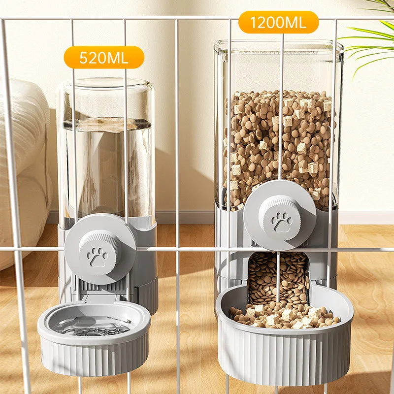 Two clear, wall-mounted pet dispensers in grey, with paw print knobs for water and food, attached to a wire cage.