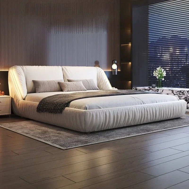 Modern king-size bed frame in cream upholstery with a curved, padded headboard and low-profile contemporary design.