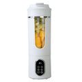 Portable white personal blender with a digital control panel and clear window showing chopped fruit inside.