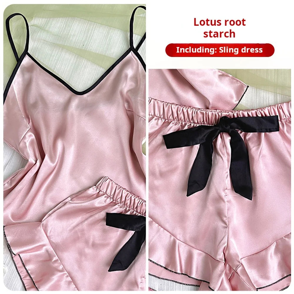 Pink satin pyjama set featuring a camisole top and frilly shorts with black trim and a decorative waist bow.