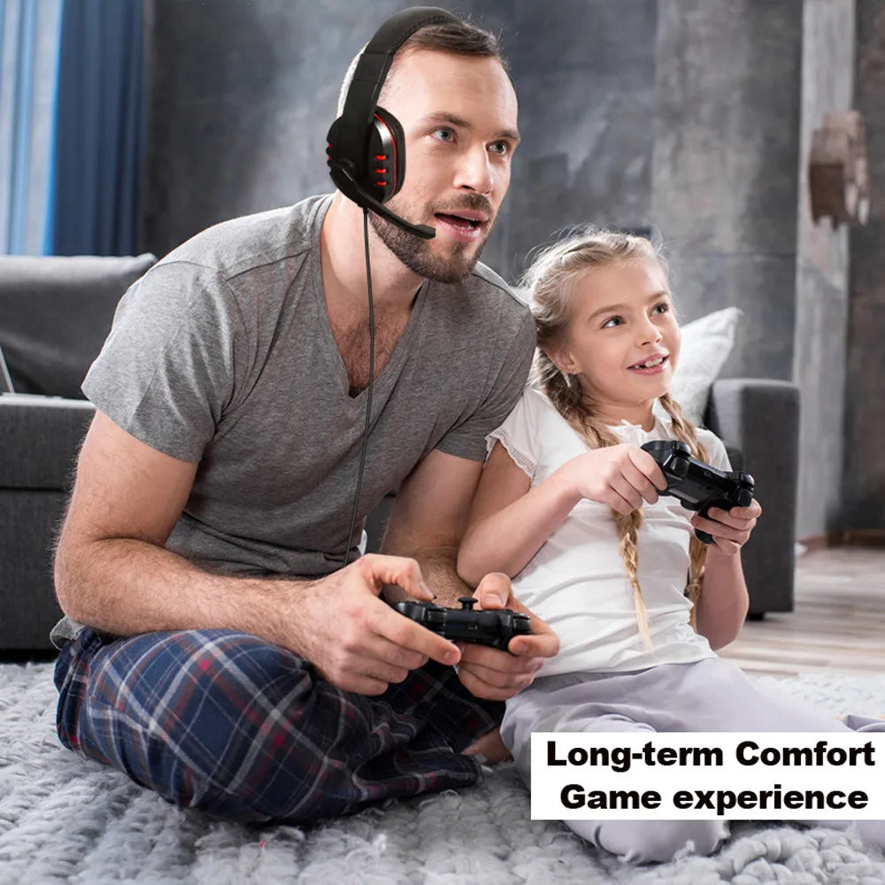 Man wearing a black wired gaming headset with red accents and an adjustable microphone while playing video games.