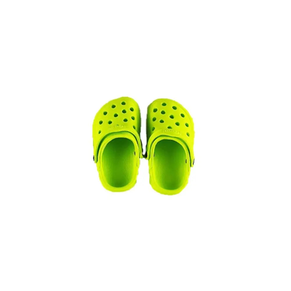 A pair of bright lime-green mini clogs with holes for ventilation and a movable heel strap, isolated on white.