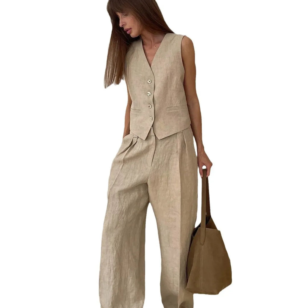 A woman wearing a beige linen-look waistcoat with button front and matching high-waisted wide-leg trousers.