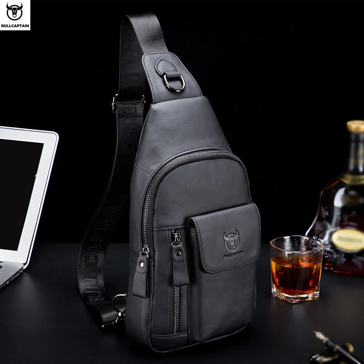 Black leather men’s crossbody sling bag with multiple zip compartments, adjustable strap and secure buckle hardware.