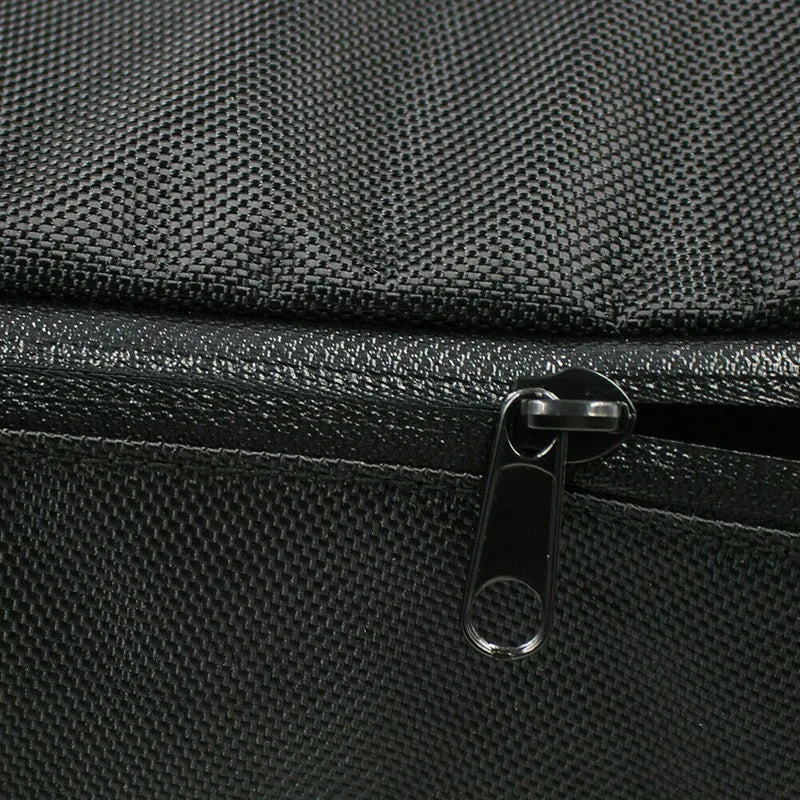 Close-up of black waterproof e-bike battery storage bag fabric texture with a zipper pull.