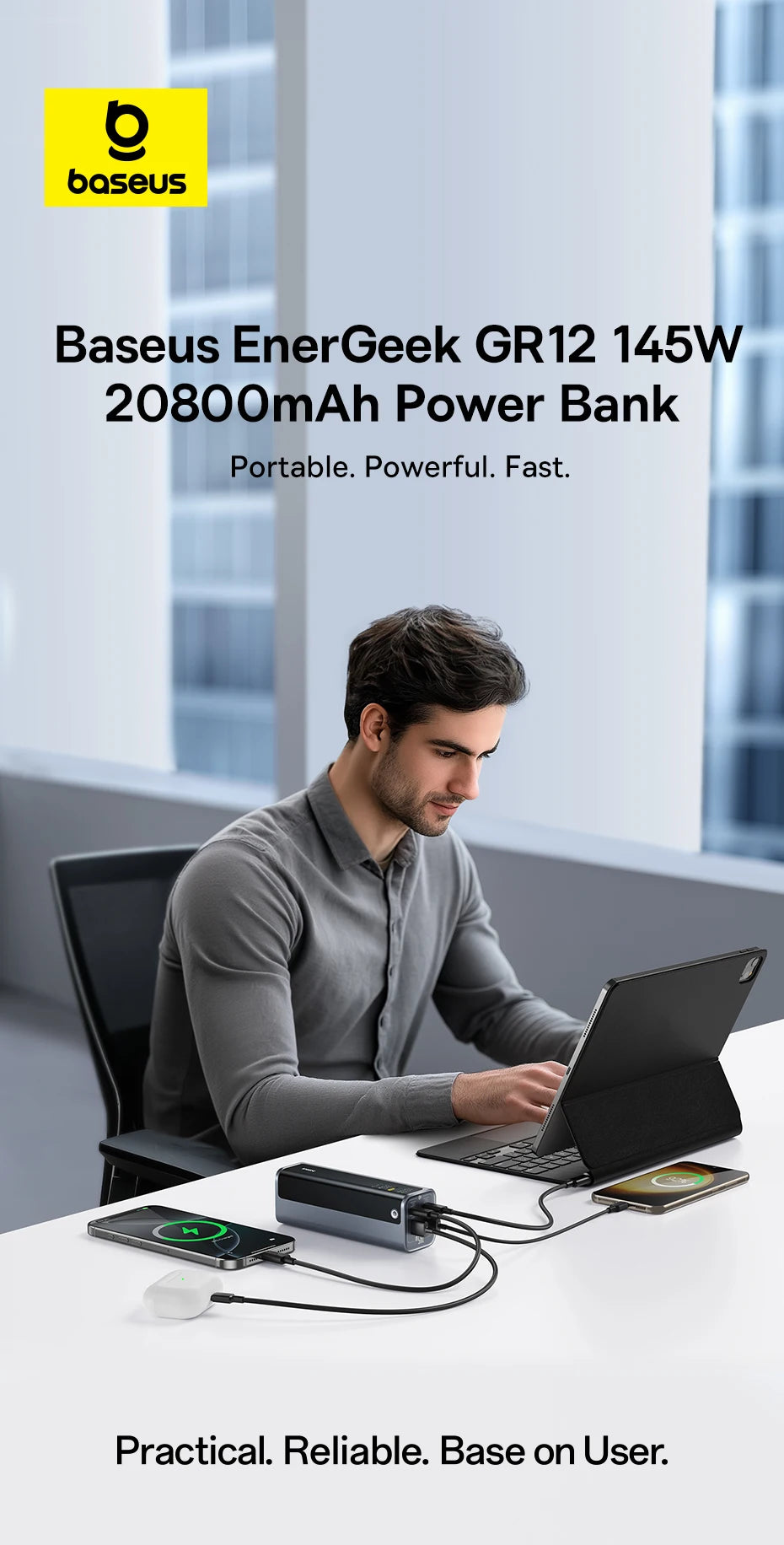 Sleek grey 145W, 20800mAh power bank charging a tablet, smartphone, and earbuds simultaneously on an office desk.