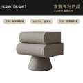 Modern light grey floating bedside table with two curved drawers and a pedestal base.