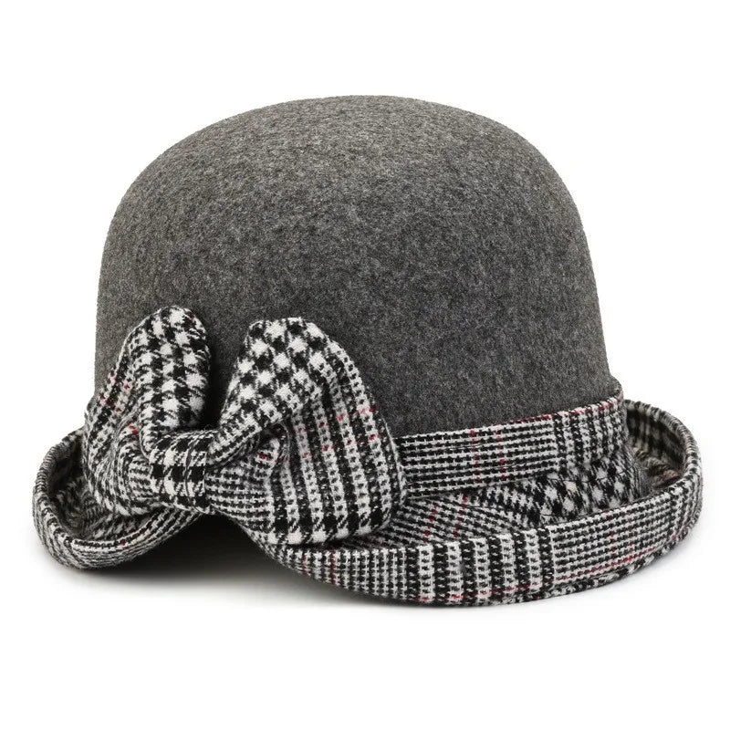 Grey felt winter bucket hat for women, featuring a decorative black and white houndstooth bow and trim.