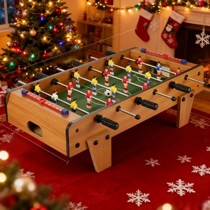Tabletop foosball game with wood-effect finish, black ergonomic handles, and sliding score trackers on a festive rug.