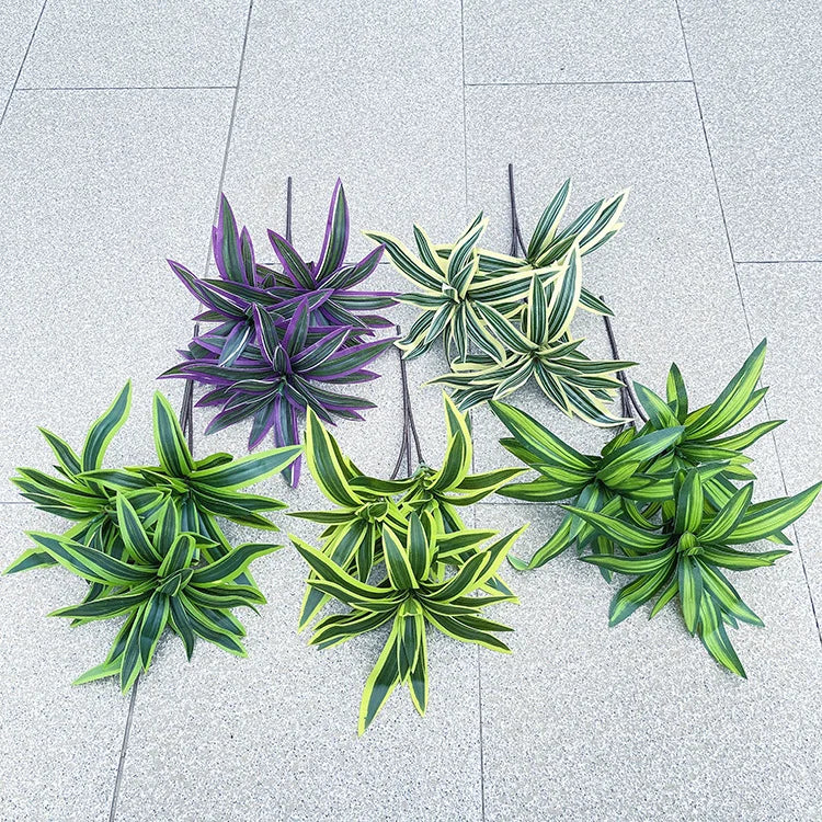 Five artificial plant stems with variegated, sword-shaped leaves in shades of purple, light yellow, and bright green.