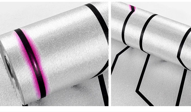 Modern, reflective silver wallpaper with a textured finish and bold geometric black and pink line patterns.