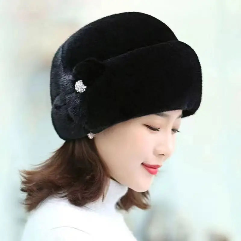 Elegant black faux fur winter hat, featuring a decorative side detail with a sparkling crystal embellishment.