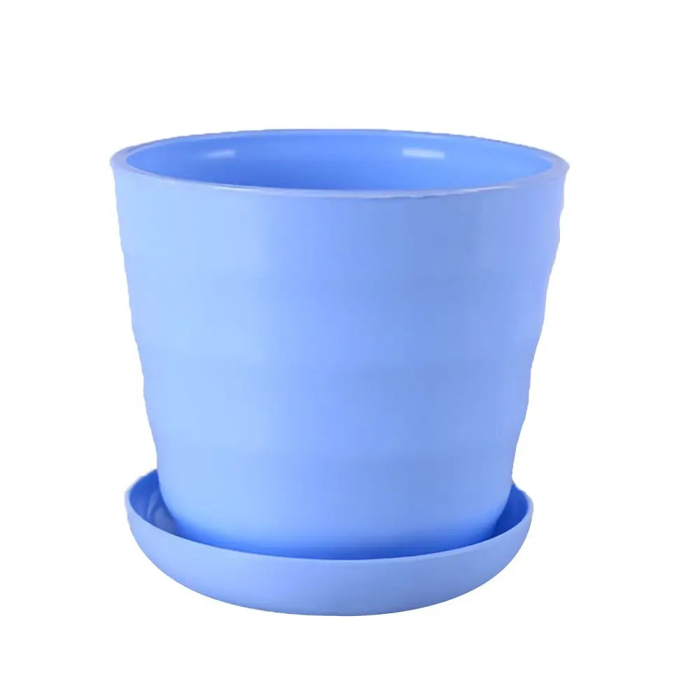 Light blue, cylindrical plastic flower pot with a subtle horizontal ribbed texture and a matching circular tray.