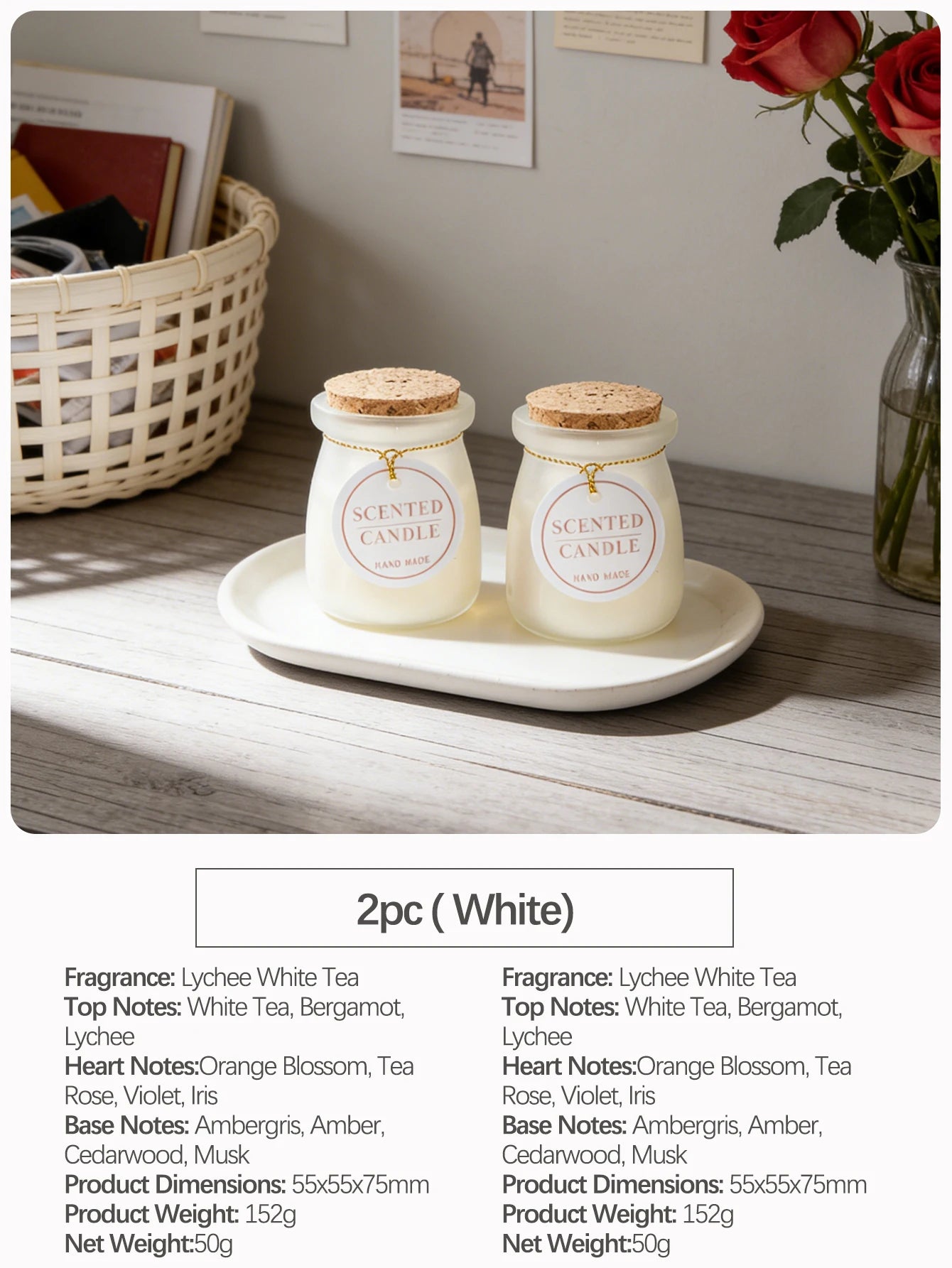 Two white scented candles in glass jars with cork lids and decorative labels, displayed on an oval tray.