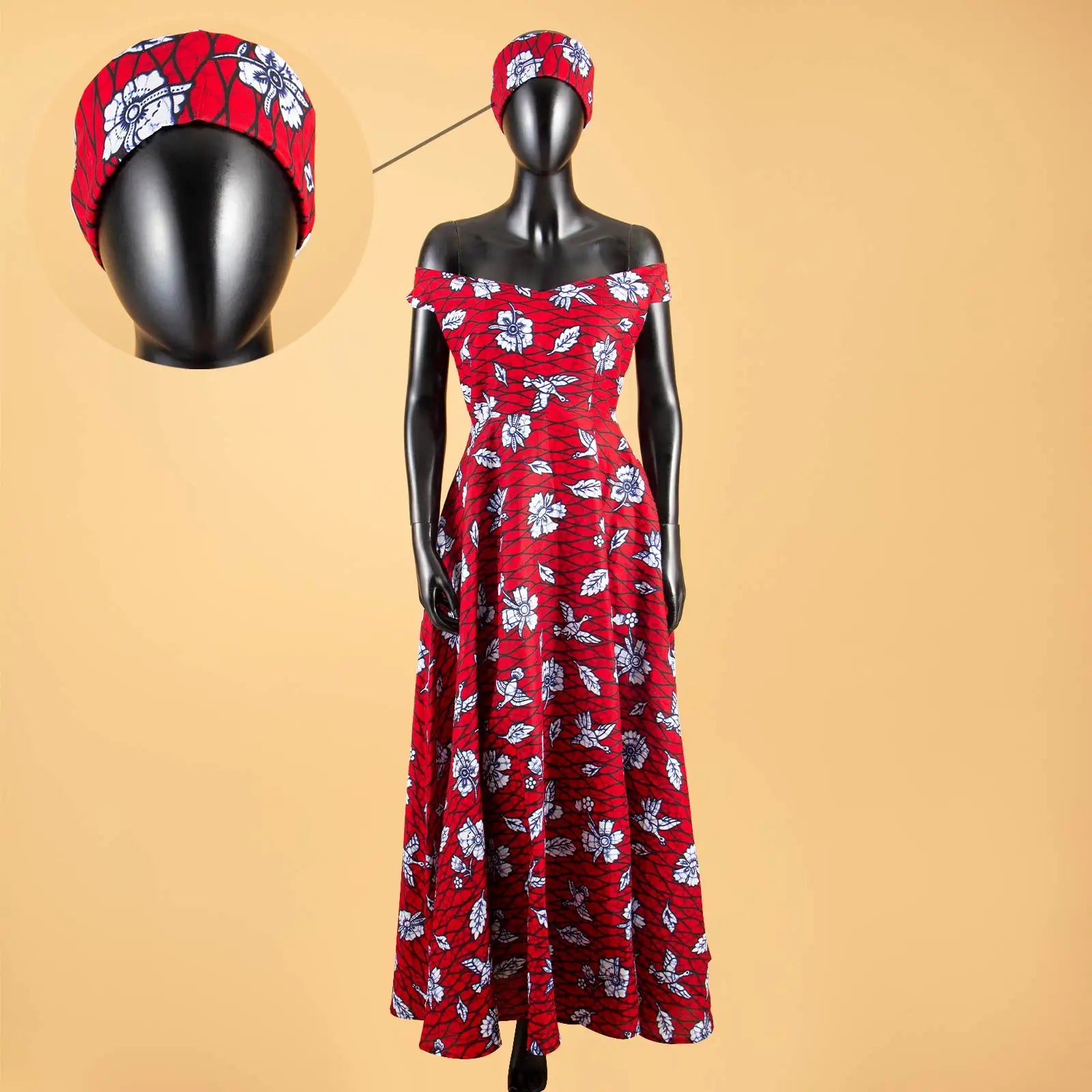Off-the-shoulder red maxi dress with a white floral print and matching headwrap on a mannequin.