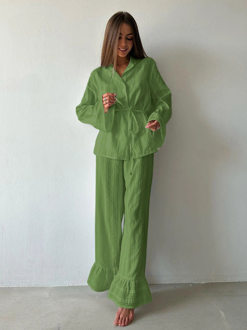 Sage green lounge set featuring a button-down shirt with a tie waist and wide-leg trousers with ruffled hems.