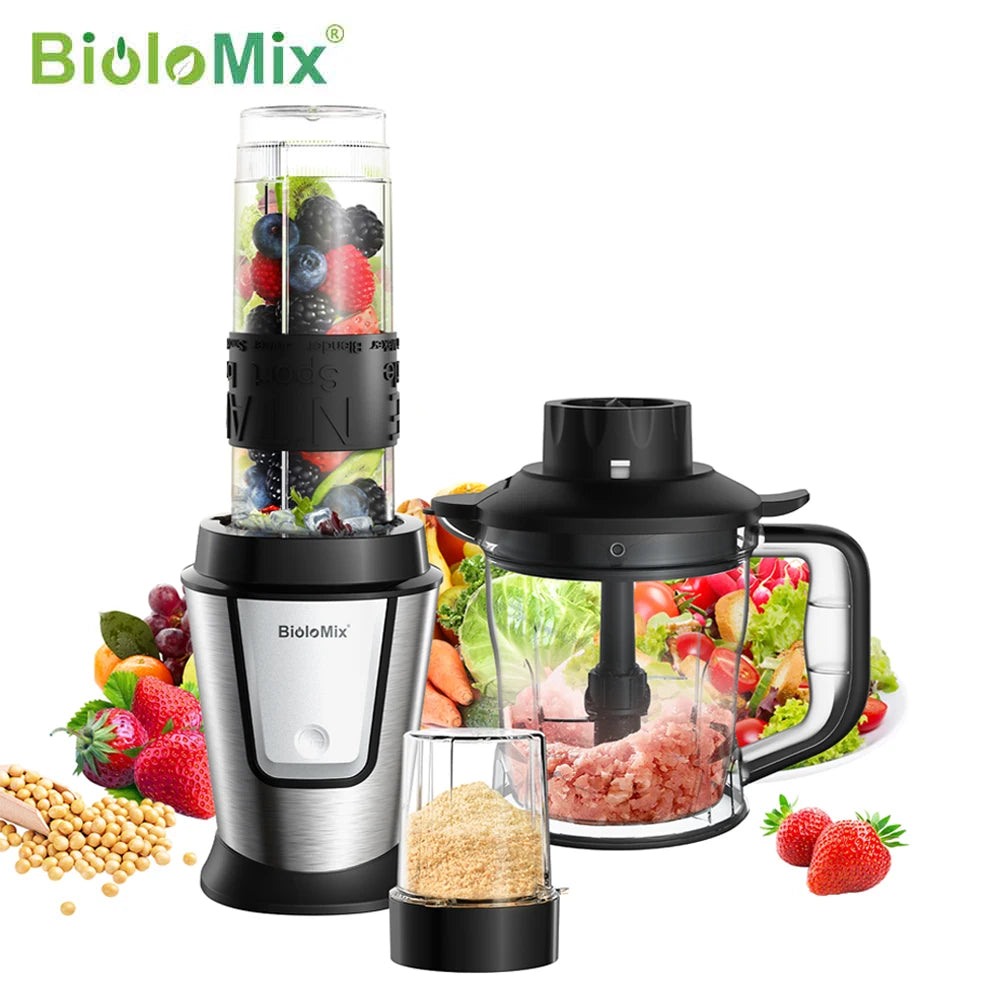 Silver and black kitchen blender set with food processor bowl, small spice grinder, and fruit/vegetable ingredients.