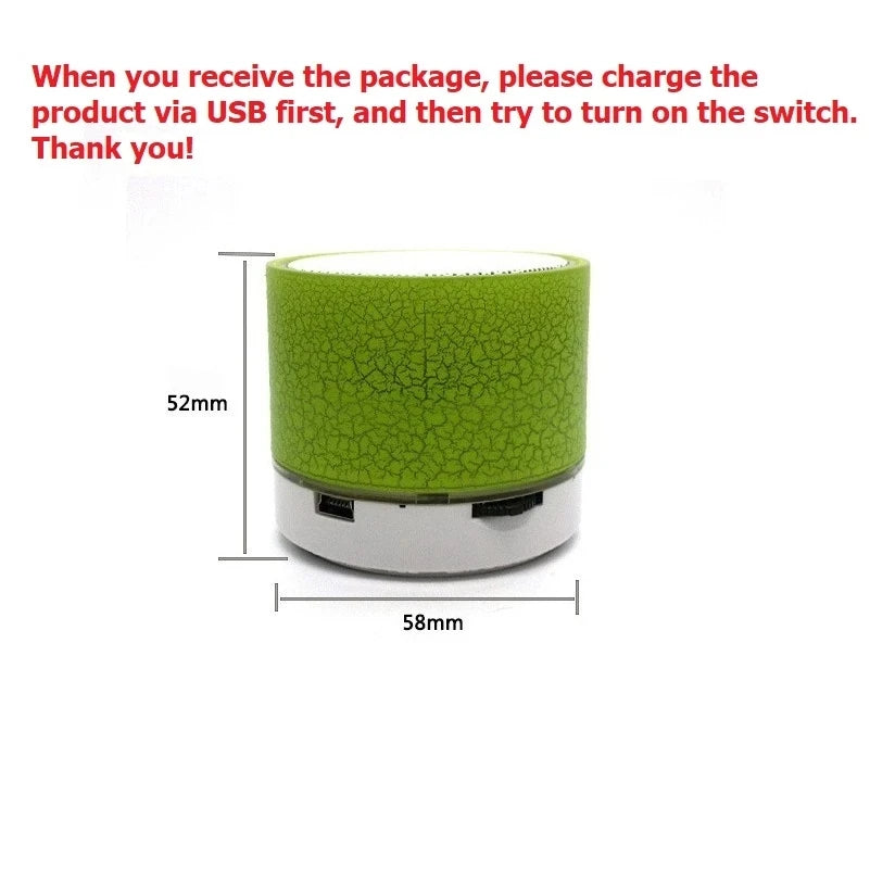 Small, portable lime green cylindrical Bluetooth speaker with a cracked-effect LED design and white base.