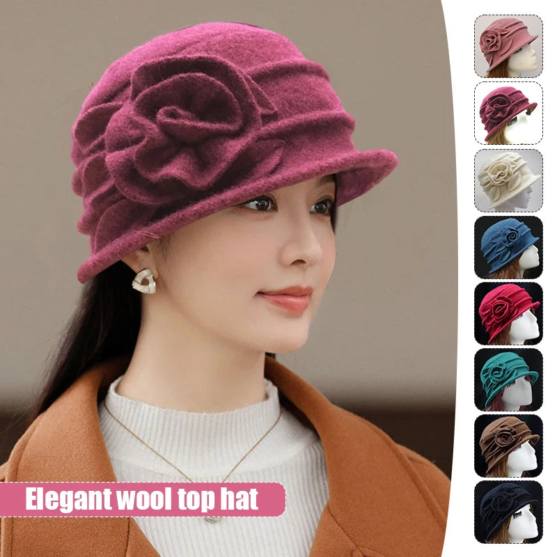 Model wearing an elegant plum-coloured wool winter hat with a side flower detail and pleated design, available in colours.
