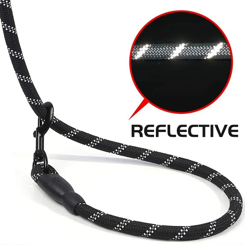 Black reflective rope dog lead with a padded handle and sturdy metal clasp. Close-up shows night-time visibility.