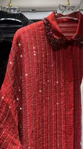 Red, pleated, long-sleeve shirt with vertical crystal stripes and a beaded collar. Button-down front, relaxed fit.