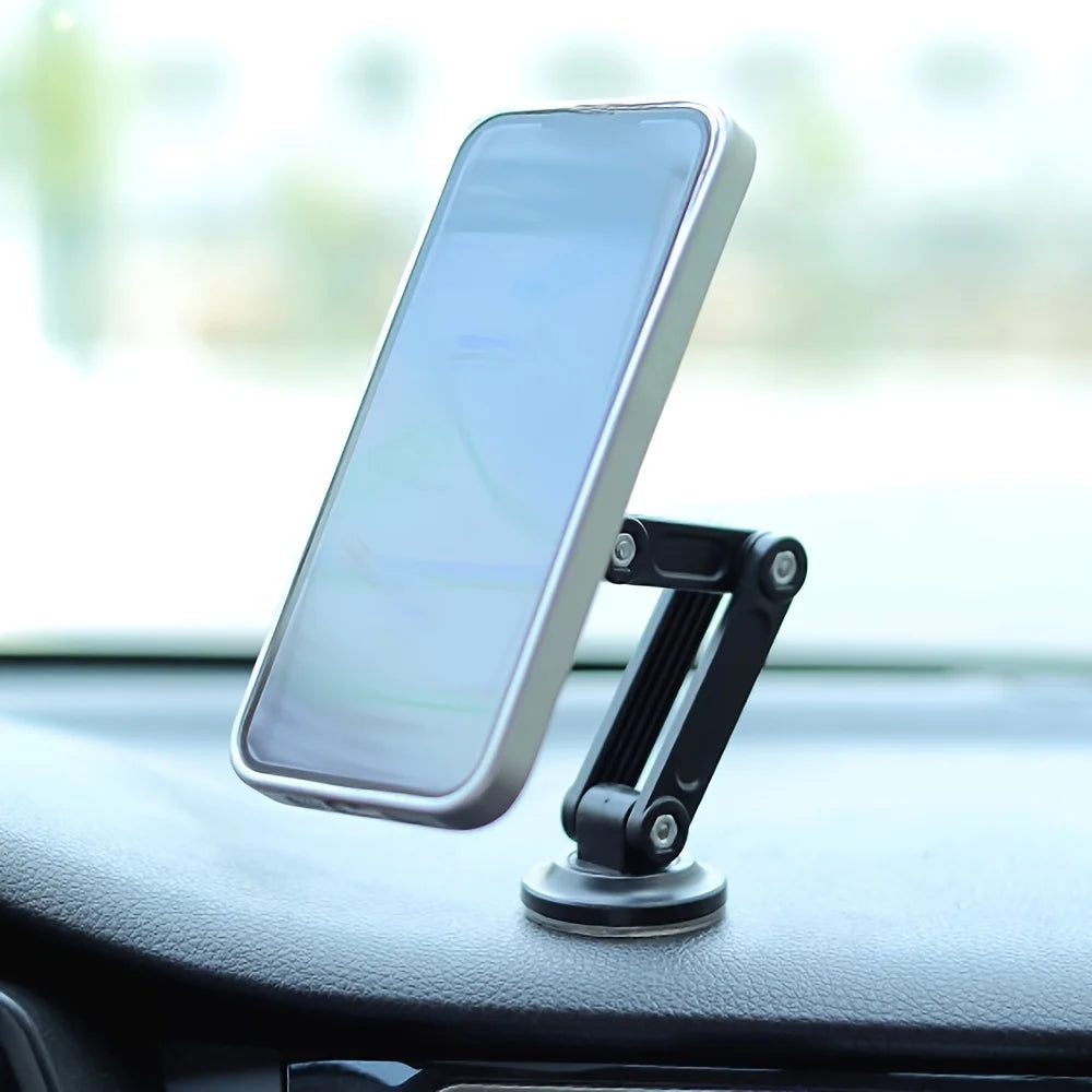 Black magnetic car phone mount with a foldable, adjustable arm, securely attached to a vehicle dashboard.