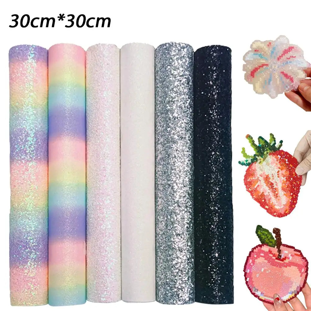 Six 30x30cm glitter and rainbow craft fabric sheets, with cut-out examples of a flower, strawberry, and apple.