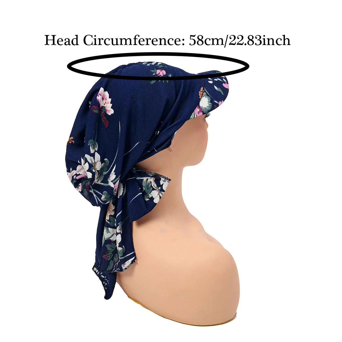 Elegant navy blue vintage-style turban hat with a floral pattern and front brim, displayed on a mannequin head.