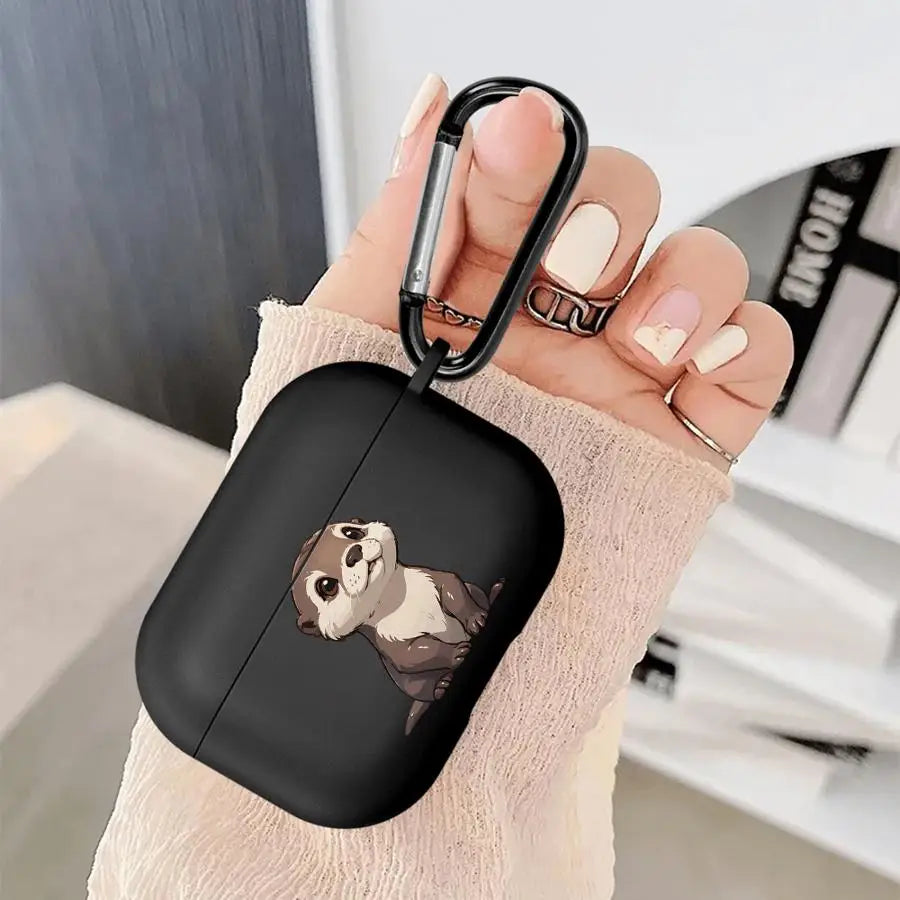 Black silicone AirPods Pro case featuring a cute otter illustration, complete with a black metal carabiner clip.