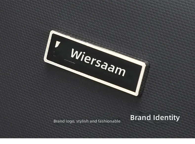 A close-up of a stylish, minimalist black metal logo plate set against the textured, waterproof material of a bag.