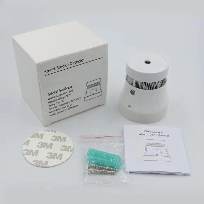 White smart WiFi smoke detector with mounting kit, screws, adhesive pad, and user manual on a white background.